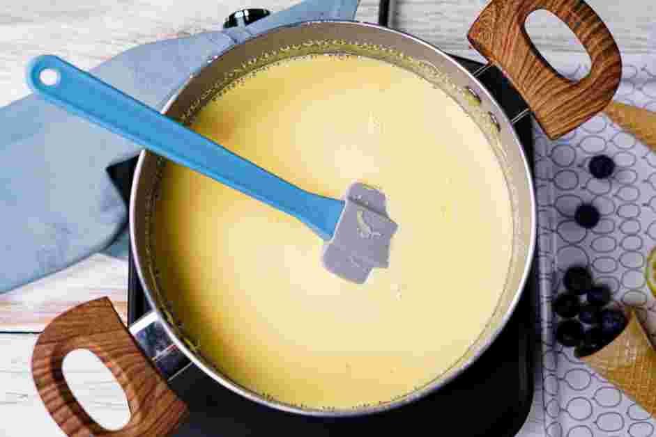 Blueberry Ice Cream Recipe: Cook over low heat, stirring constantly and scraping the bottom with a heat-resistant spatula until the custard thickens enough to coat the spatula or an instant-read thermometer reads 170°F to 175°F.