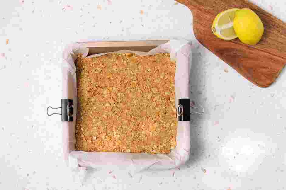 Lemon Cheesecake Bars Recipe: Transfer the mixture into the prepared baking pan and press the mixture into the bottom.
