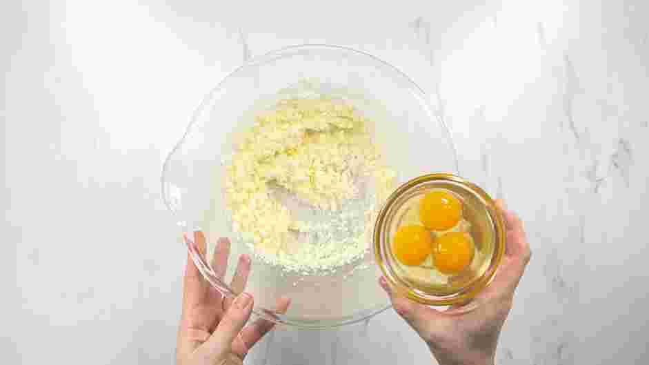 Strawberry Crunch Cake Recipe: Add the eggs and egg yolk and mix until combined.